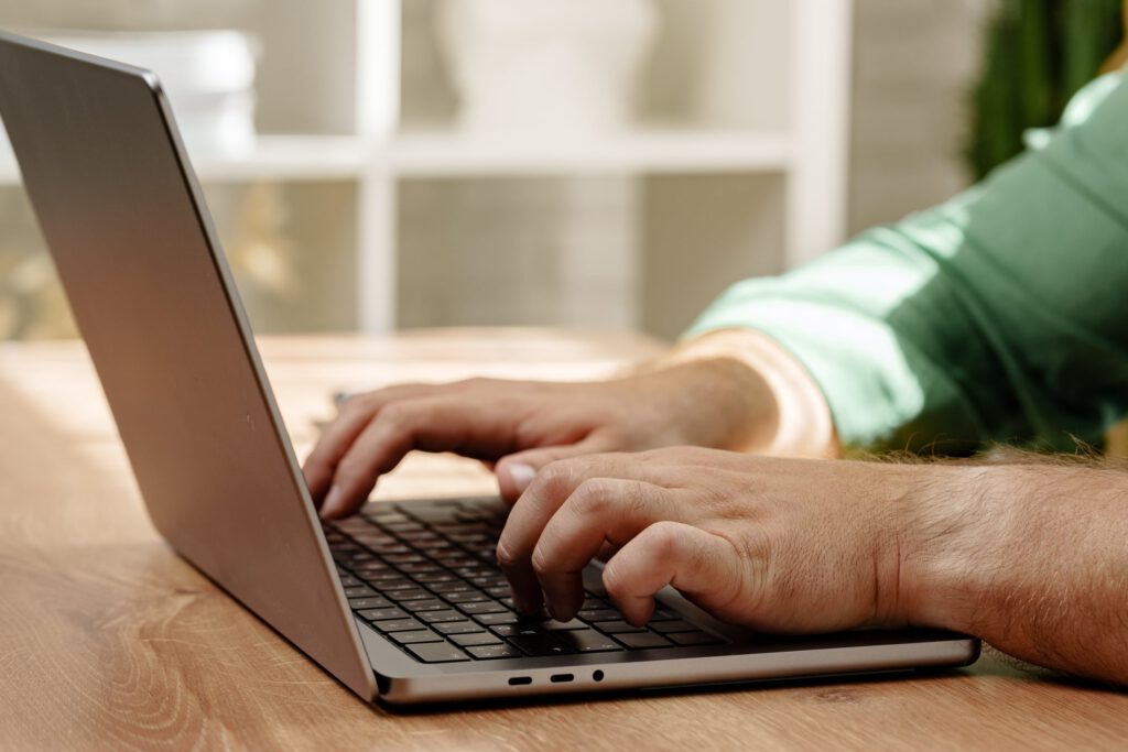 Person accessing online mental health resources and information on a laptop
