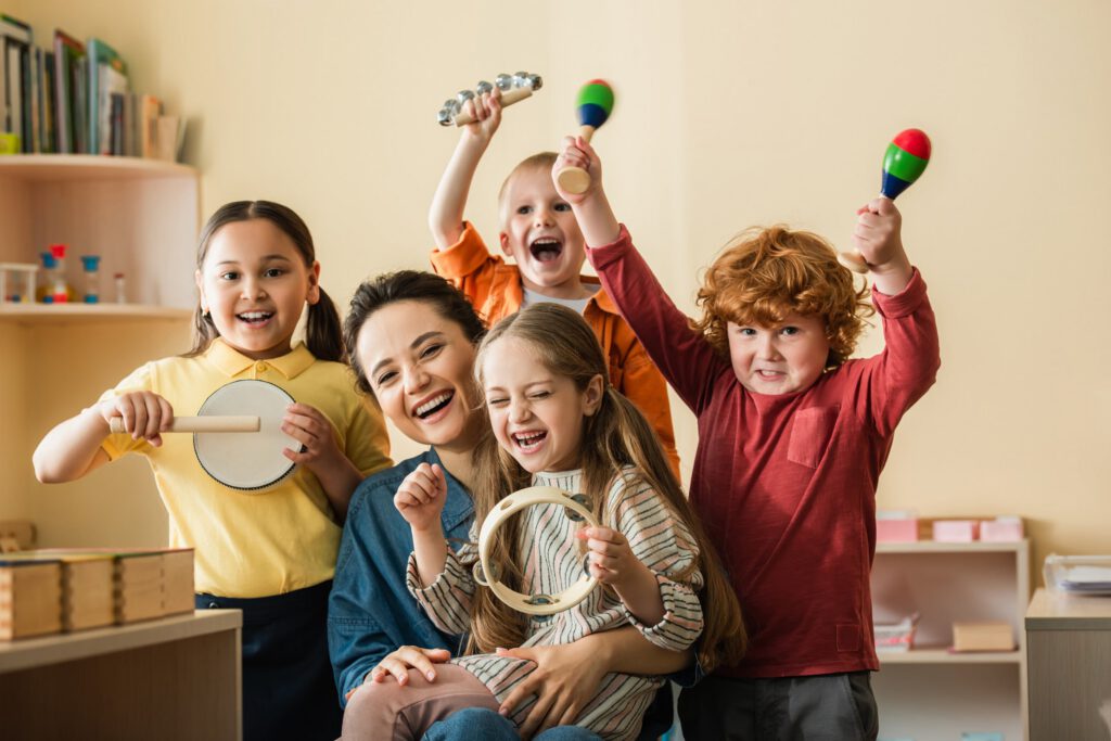 Group of children and an adult holding musical instruments during a music activity
