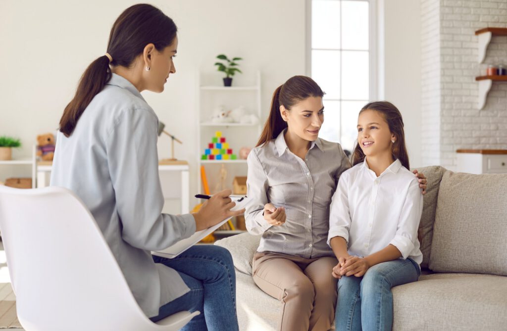 Therapist meeting with a parent and child during a family counseling session