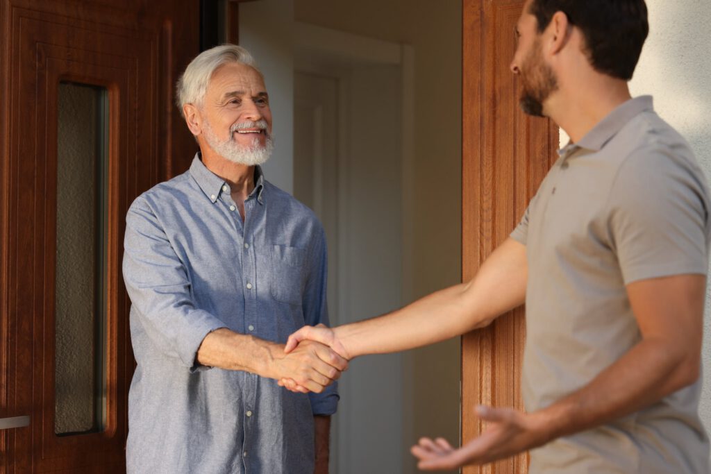 Care coordinator greeting client during home visit