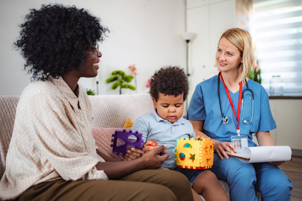 In-home behavioral health therapist working with a family and young child